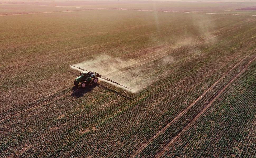 Tractor on Dead Field on Monoculture Crops