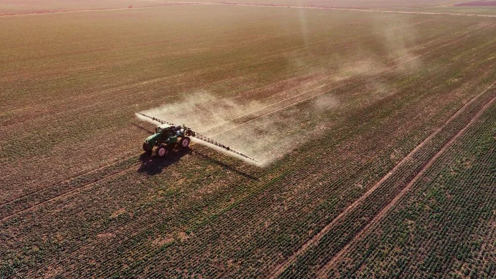 Tractor on Dead Field on Monoculture Crops