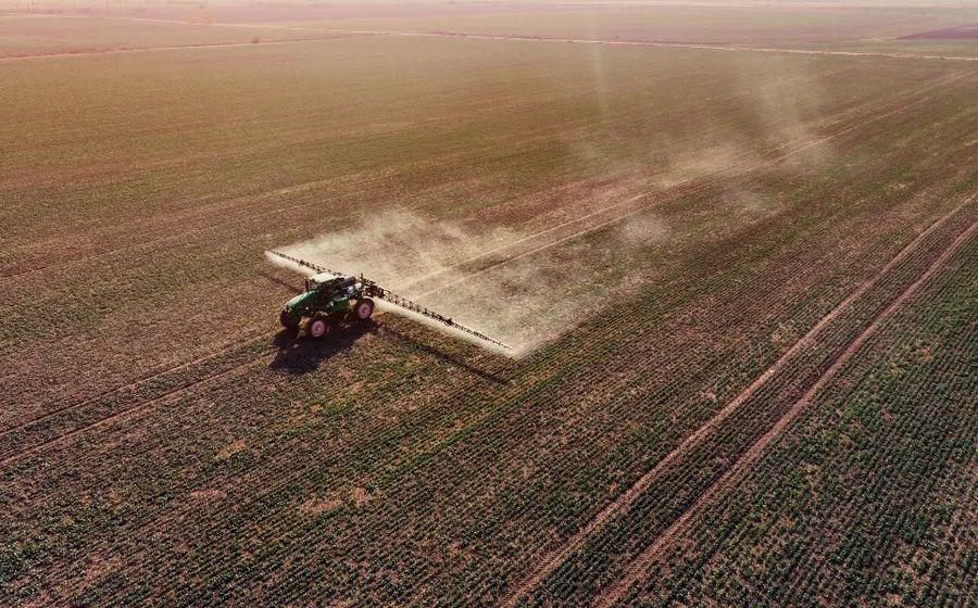 Tractor on Dead Field on Monoculture Crops