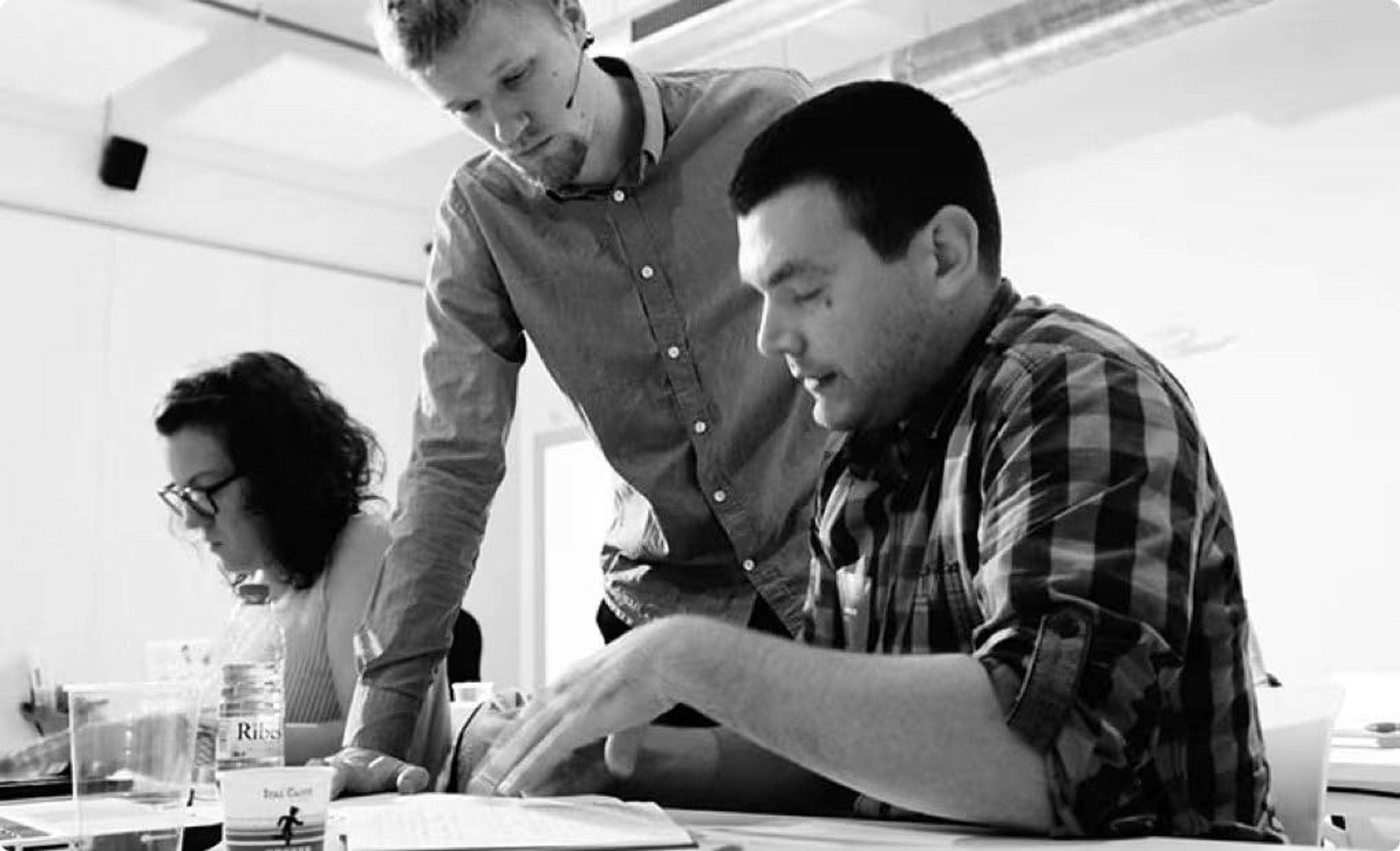 Baymard co-founder Christian Holst in a UX workshop with two participants (one male, one female)