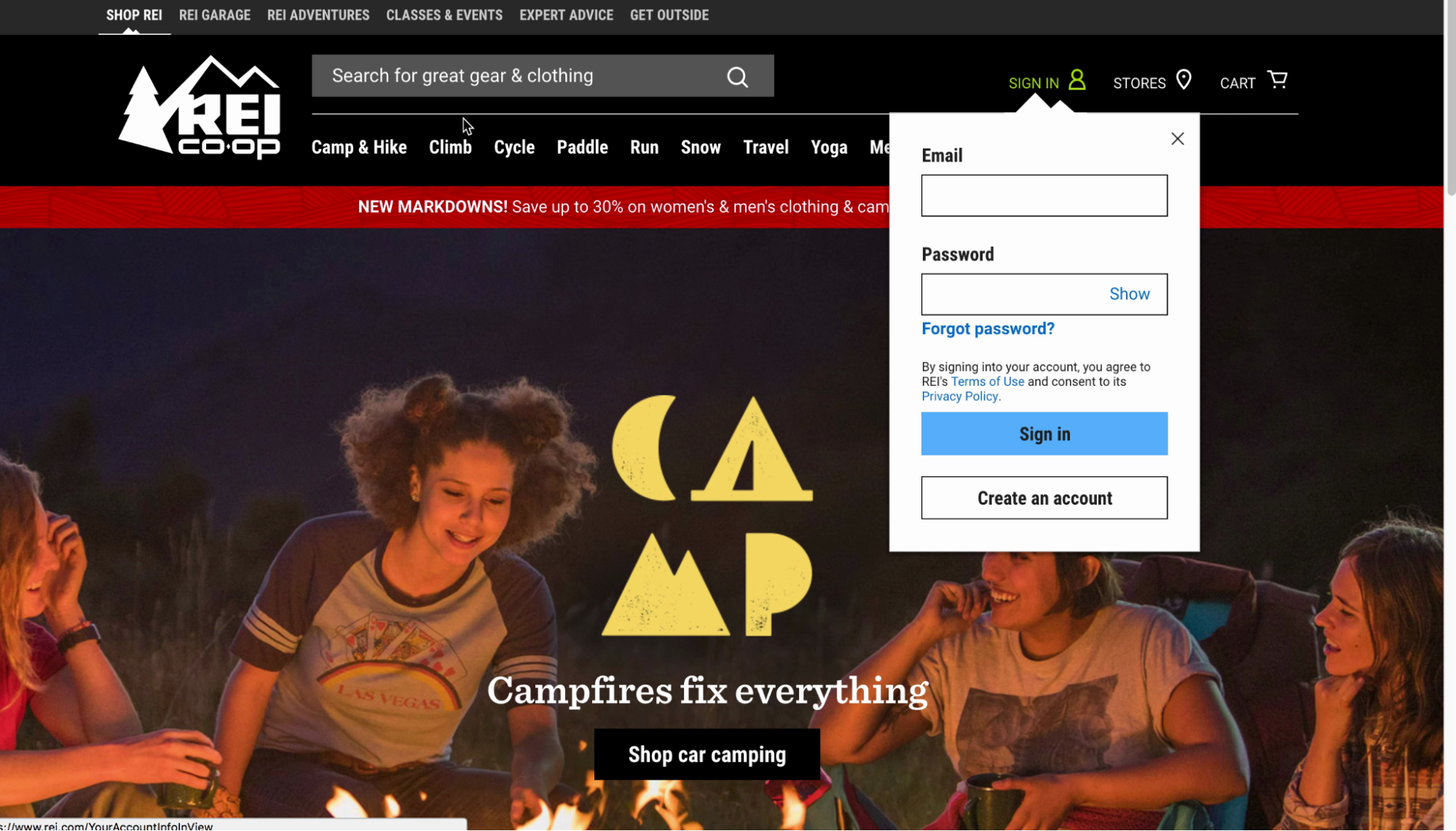 REI homepage with camping banner, showing the account login in a dropdown from the main menu