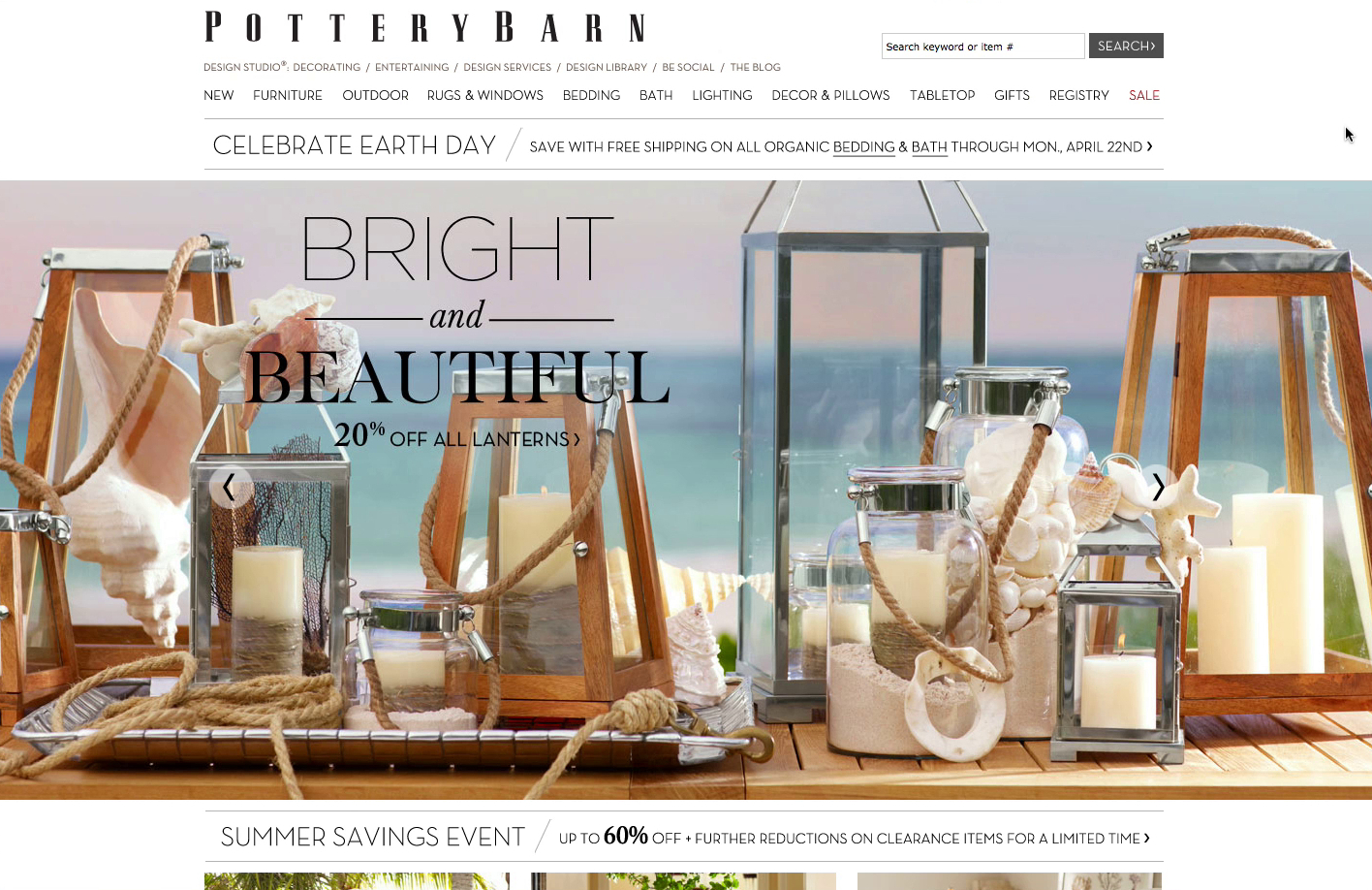 Pottery Barn homepage with high quality lifestyle imagery of lanterns on a table with the sea in the background