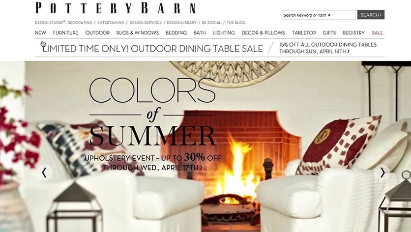 Pottery Barn homepage with banner of armchairs in front of a fireplace, with text overlaid on the image that is difficult to read