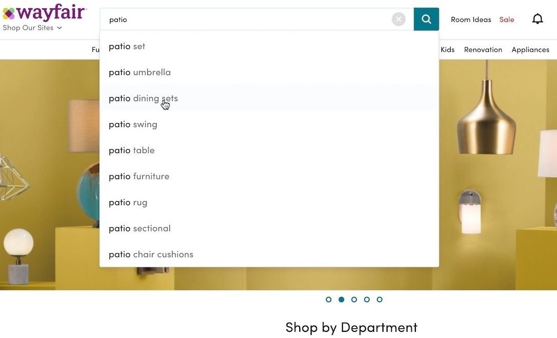 Wayfair homepage with autocomplete suggestions in the search bar as a user searches "patio"