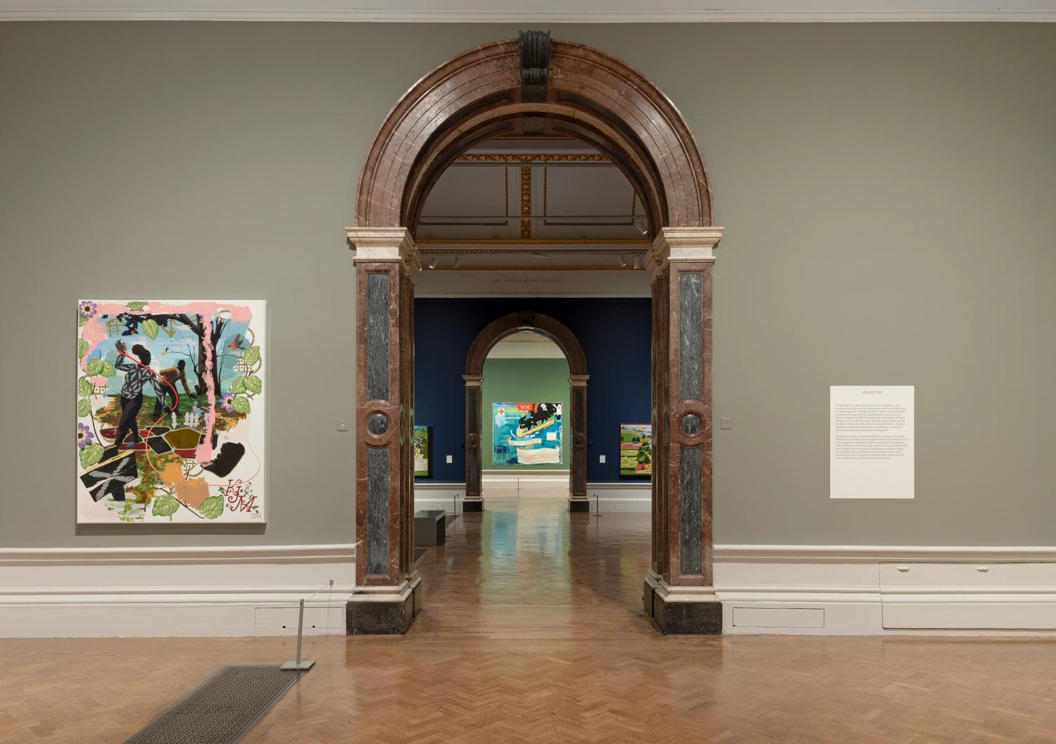 Gallery view of Kerry James Marshall exhibition; vibrant paintings hang alongside graphic interpretation panels.