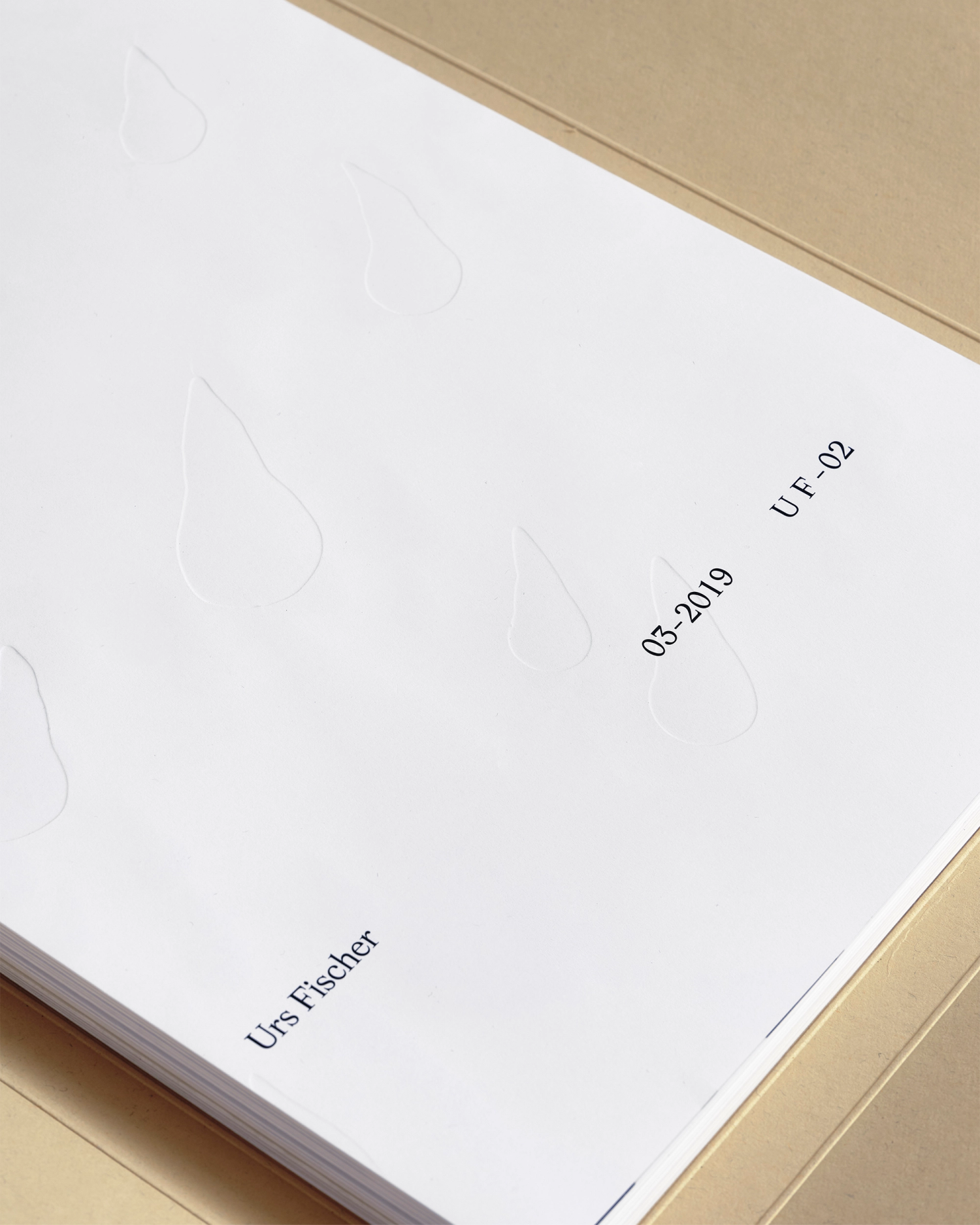 Photograph of a stack of paper with embossed raindrops