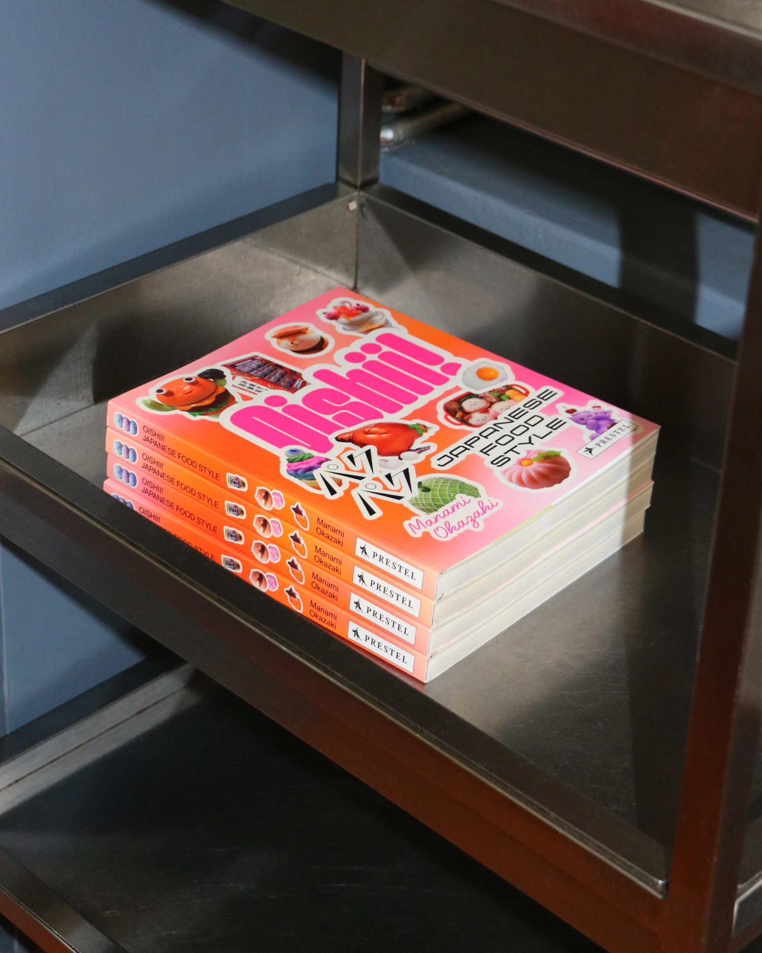Stack of Oishii! books on a stainless steel food trolley