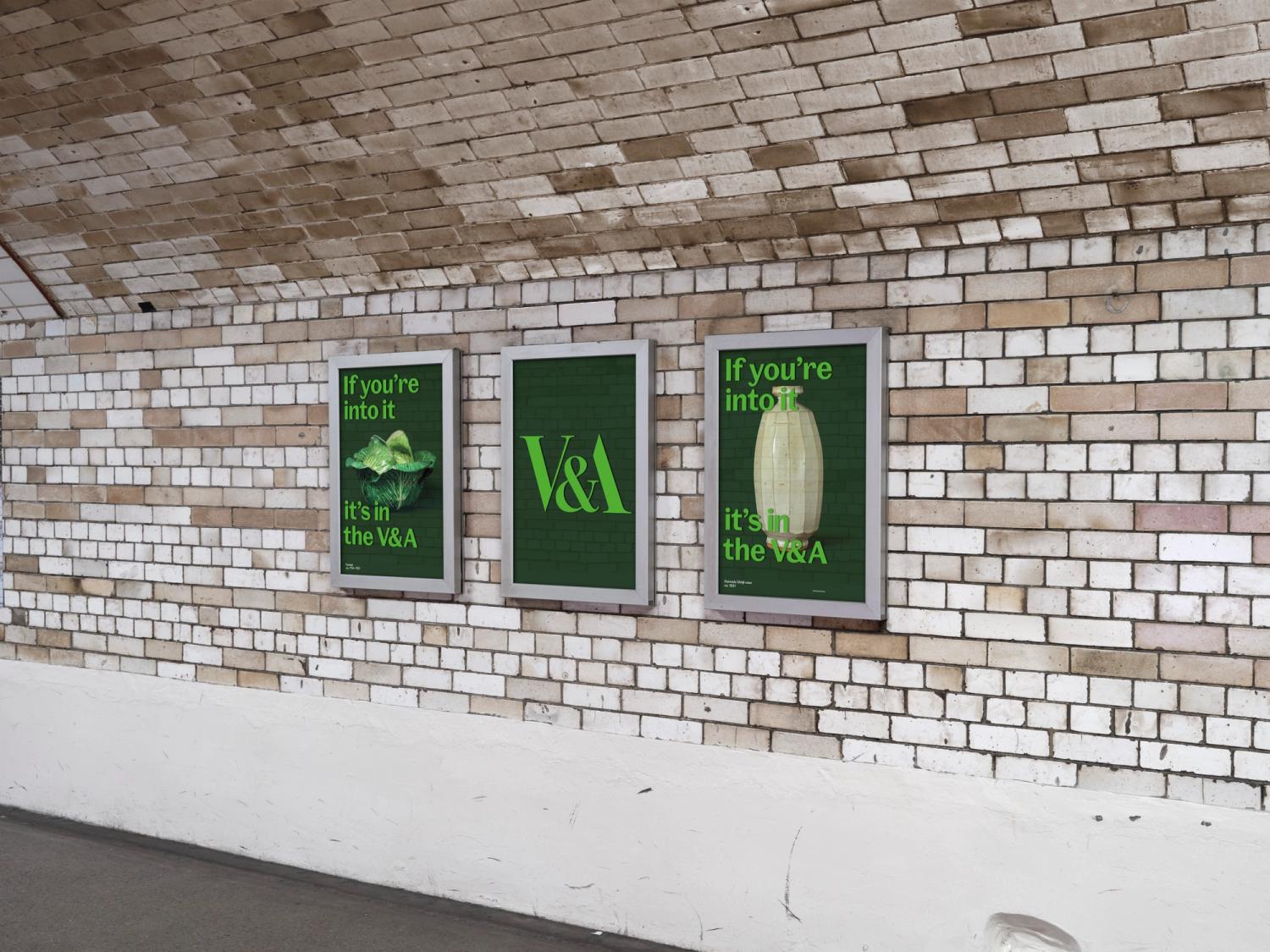 A set of three dark green posters in frames along the wall of a tiled underground tunnel. Each poster has light green type printed to the glass in front.