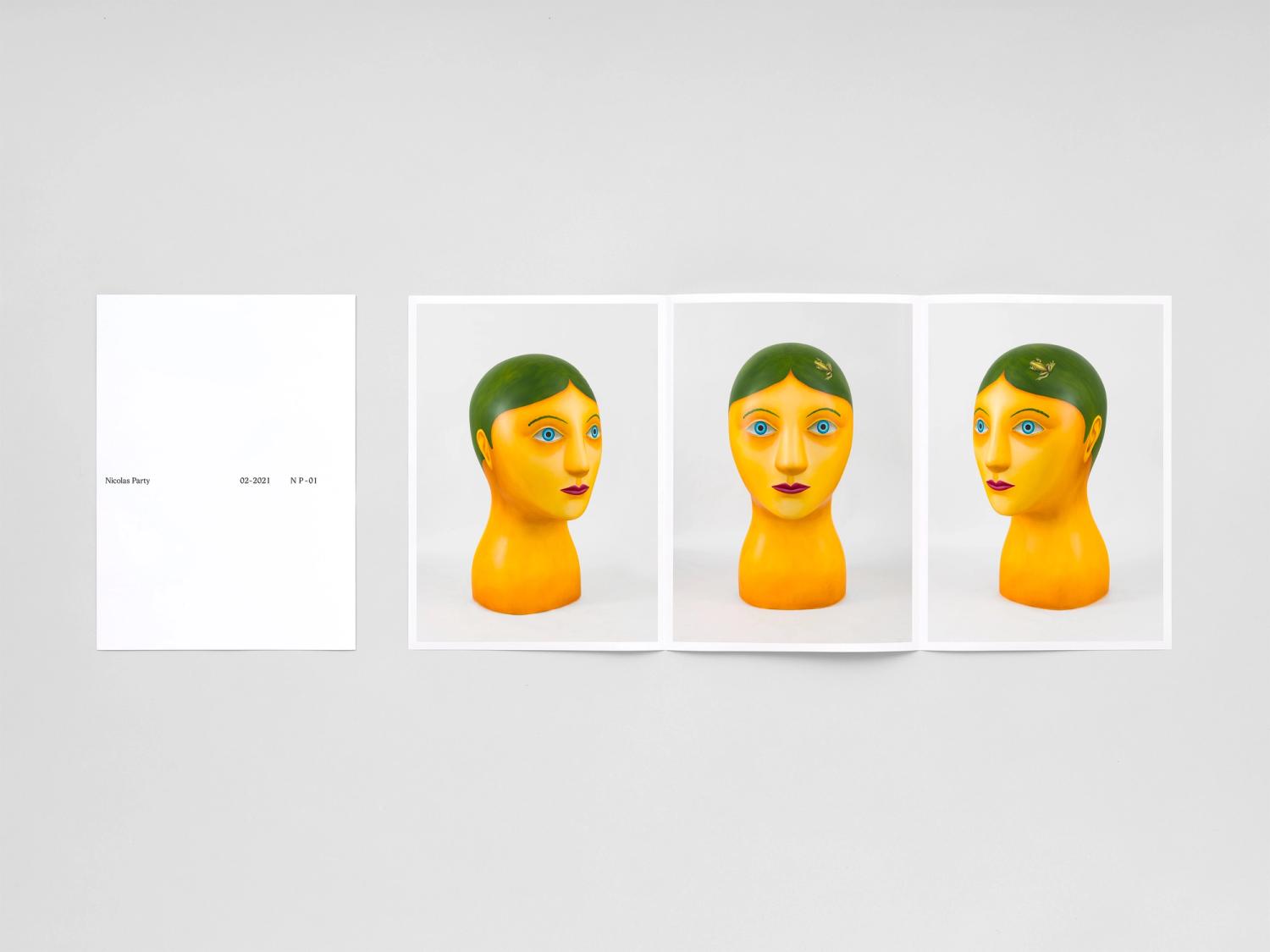 Photograph of a folded and unfolded sheet of white paper with printed images of a bust sculpture