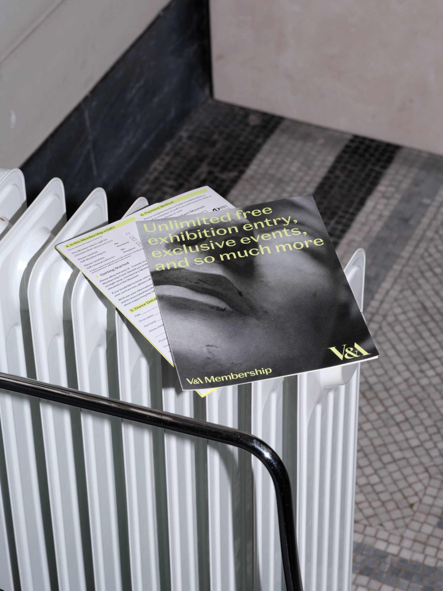A photograph of an information booklet resting on a portable radiator.
