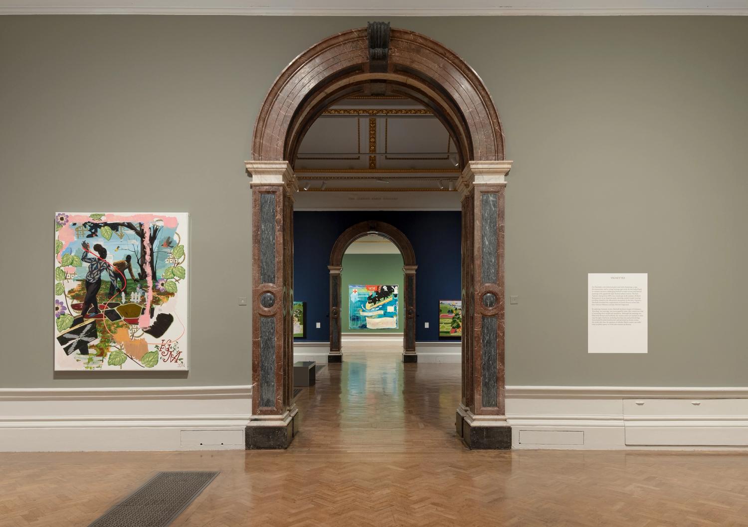 Gallery view of Kerry James Marshall exhibition; vibrant paintings hang alongside graphic interpretation panels.