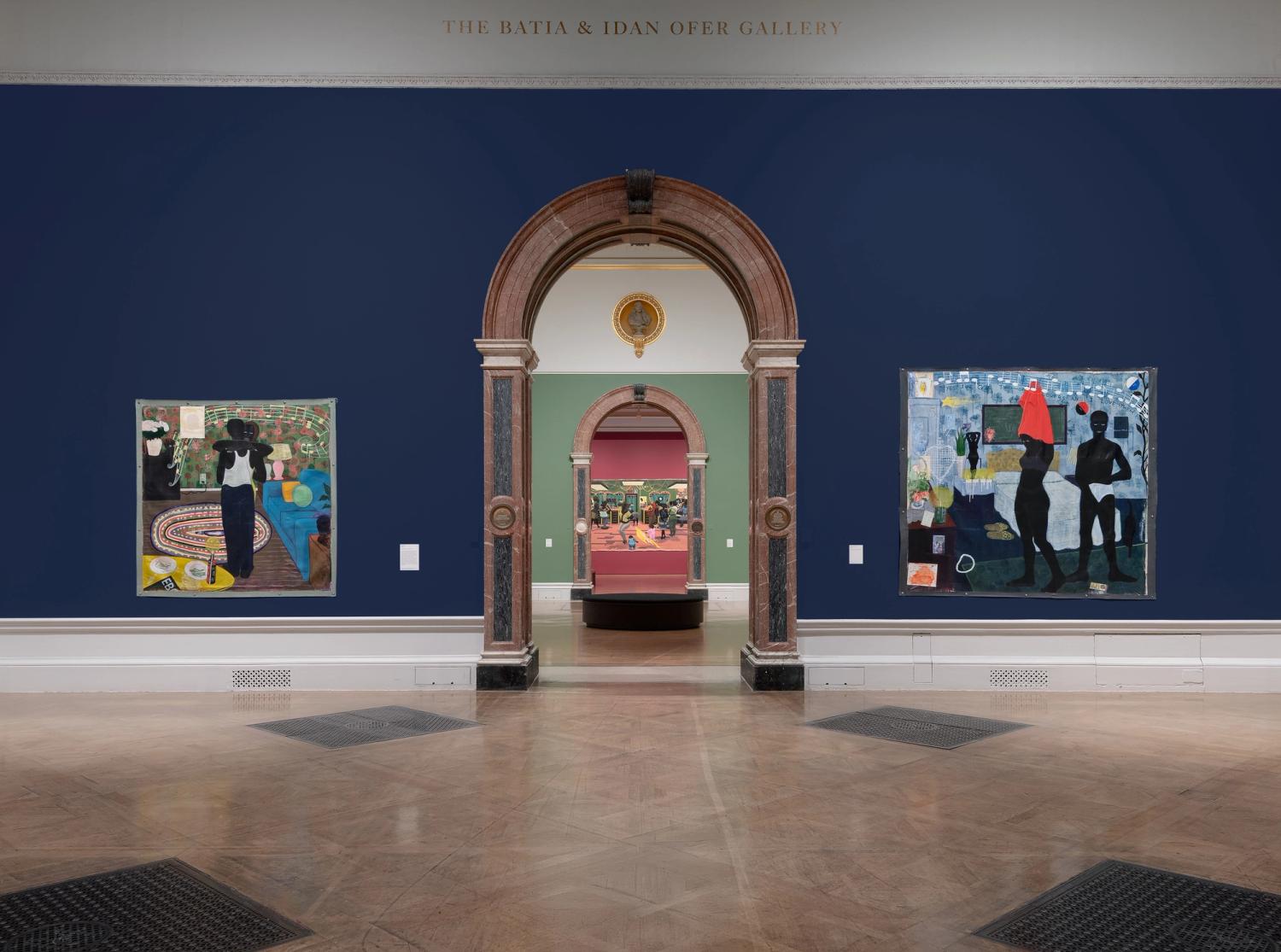 Two colourful artworks on blue walls, framing an arch leading to another vibrant painting on a green wall.