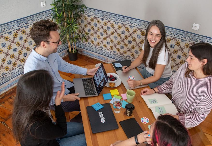 Global software engineering team collaborating across modern workspaces.
