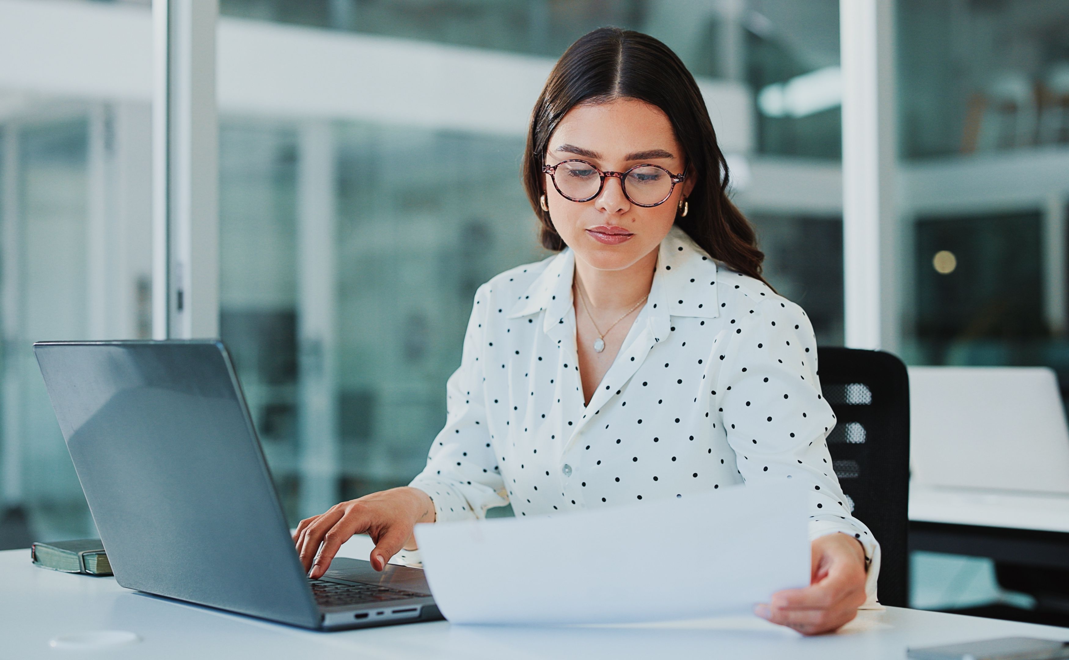 Documents, laptop and business woman working on a product roadmap