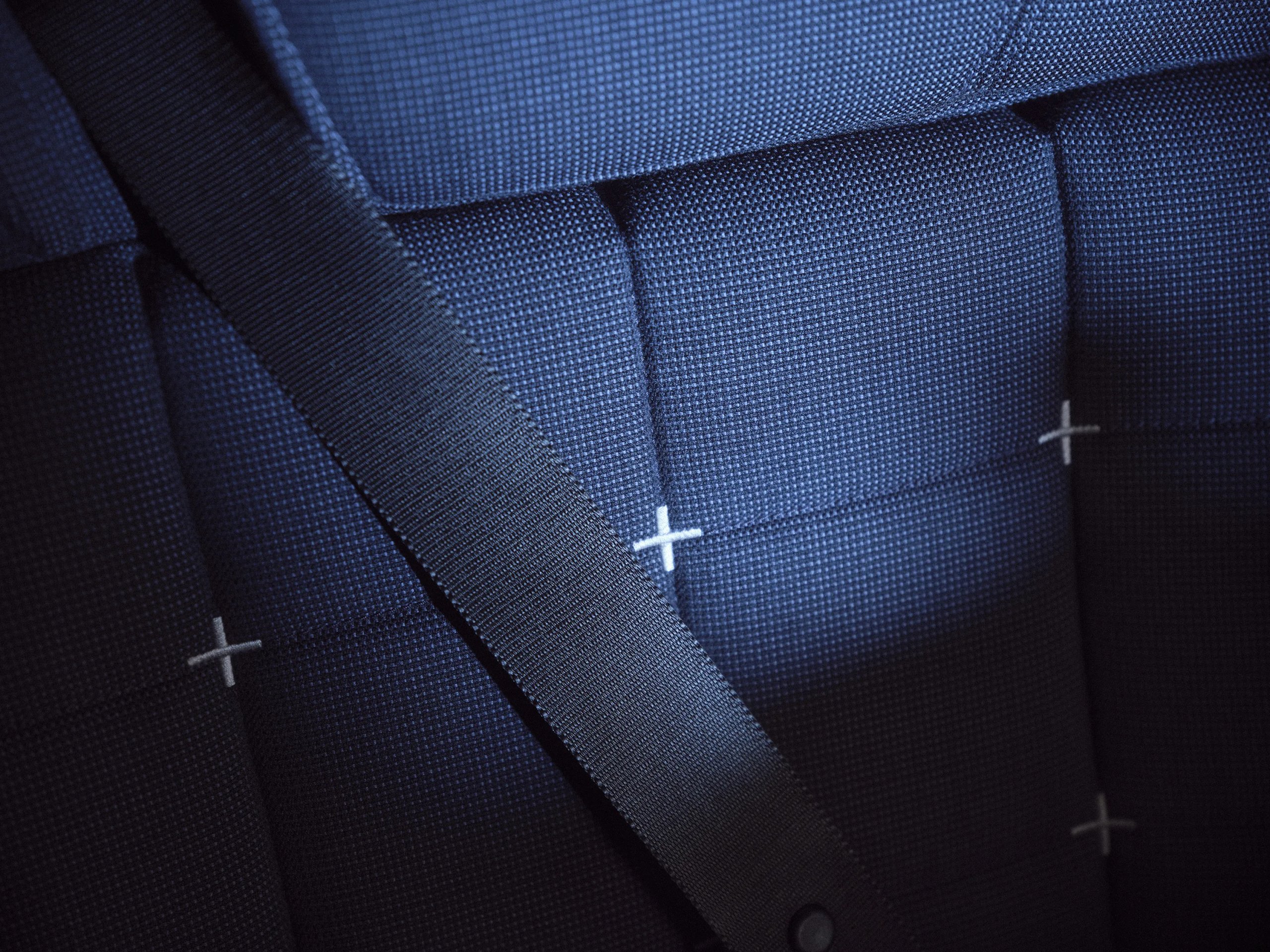 Close-up of British Airways premium seat upholstery with cross-stitch detail in navy blue