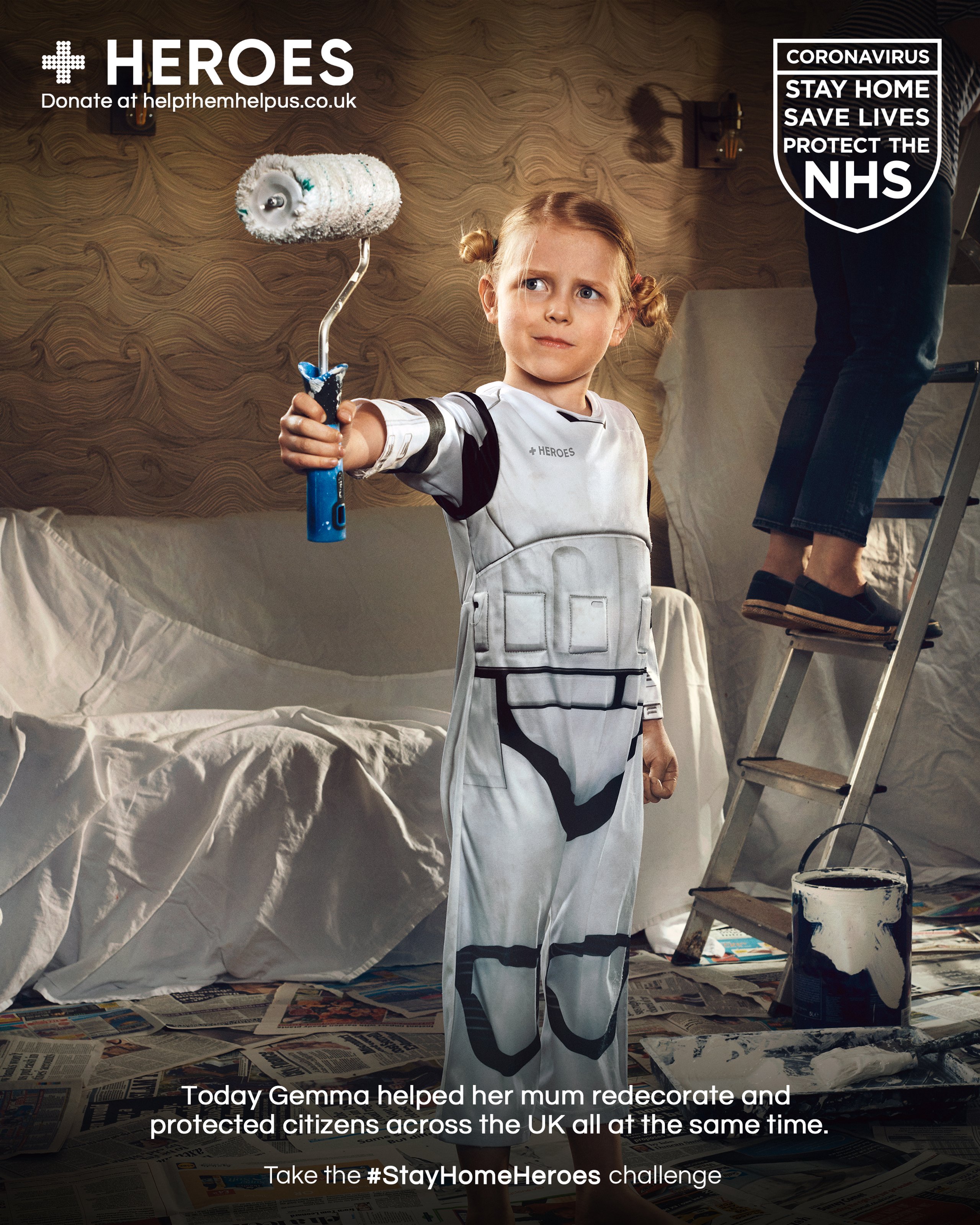 Girl in Stormtrooper costume holding paint roller while helping mum redecorate for Stay Home Heroes