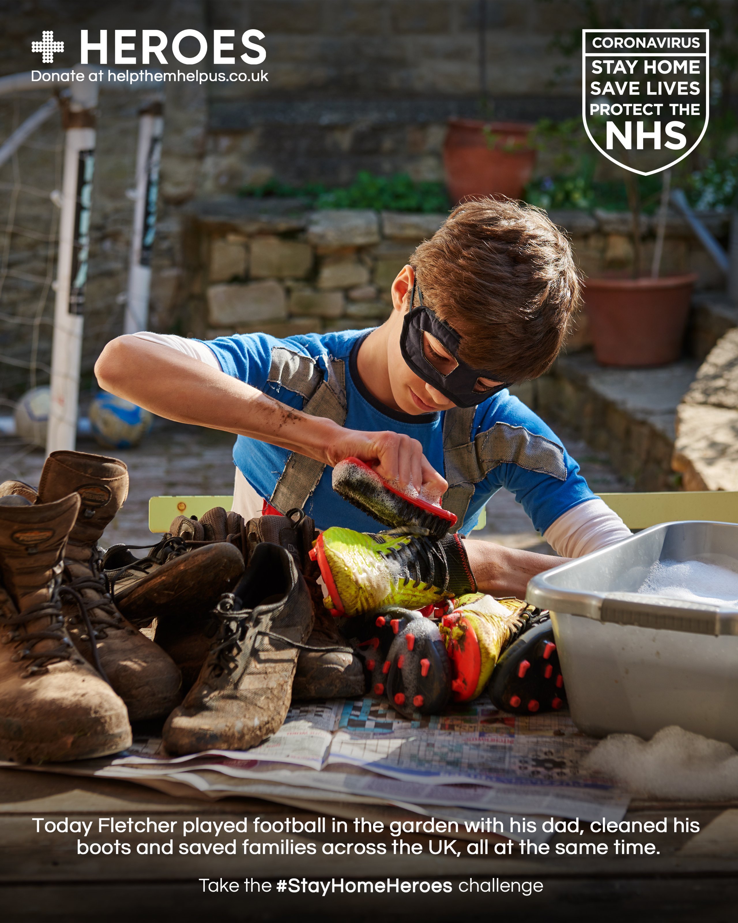 Boy in superhero mask cleaning football boots in garden for Stay Home Heroes campaign