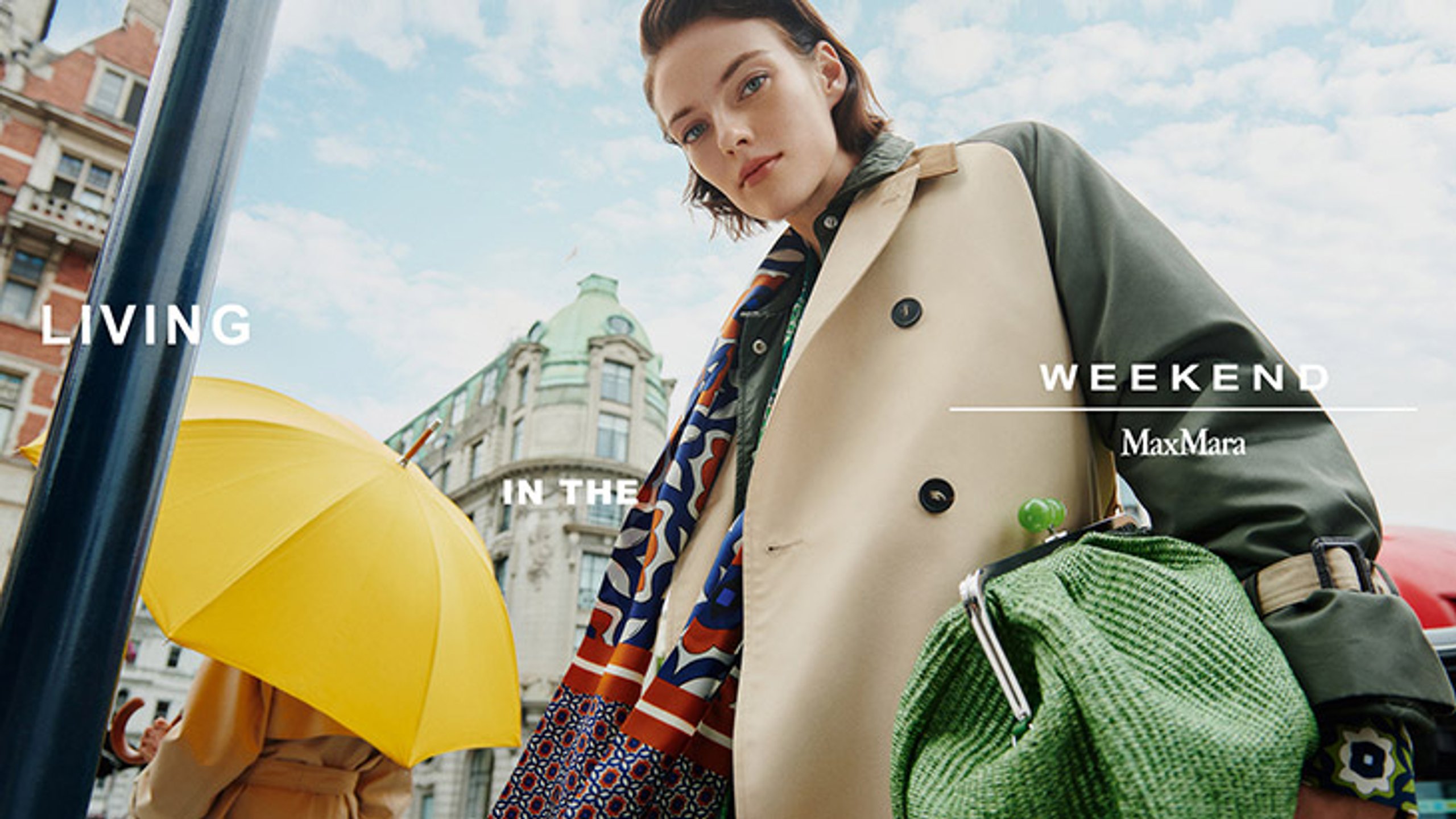 MaxMara Weekend Living In The Weekend campaign banner with model in colour-block trench coat and green woven bag