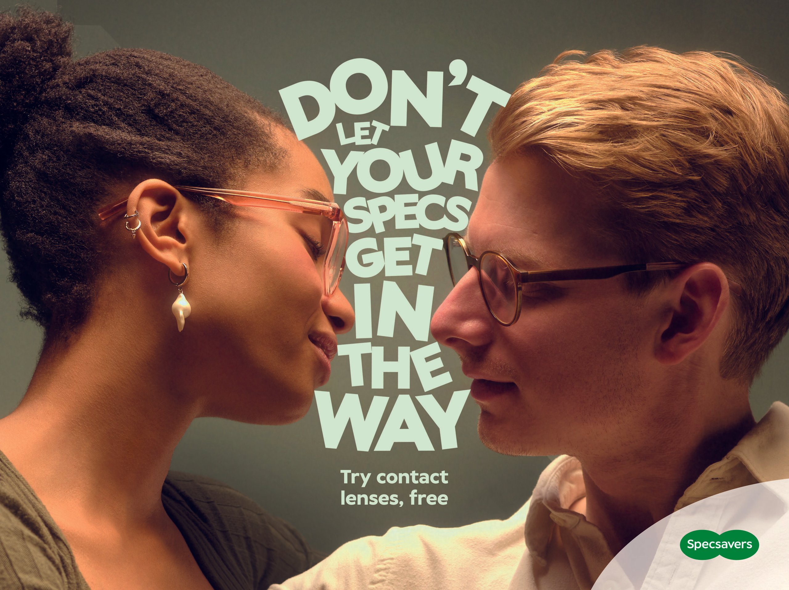 Couple about to kiss with glasses clashing and Specsavers contact lens campaign typography