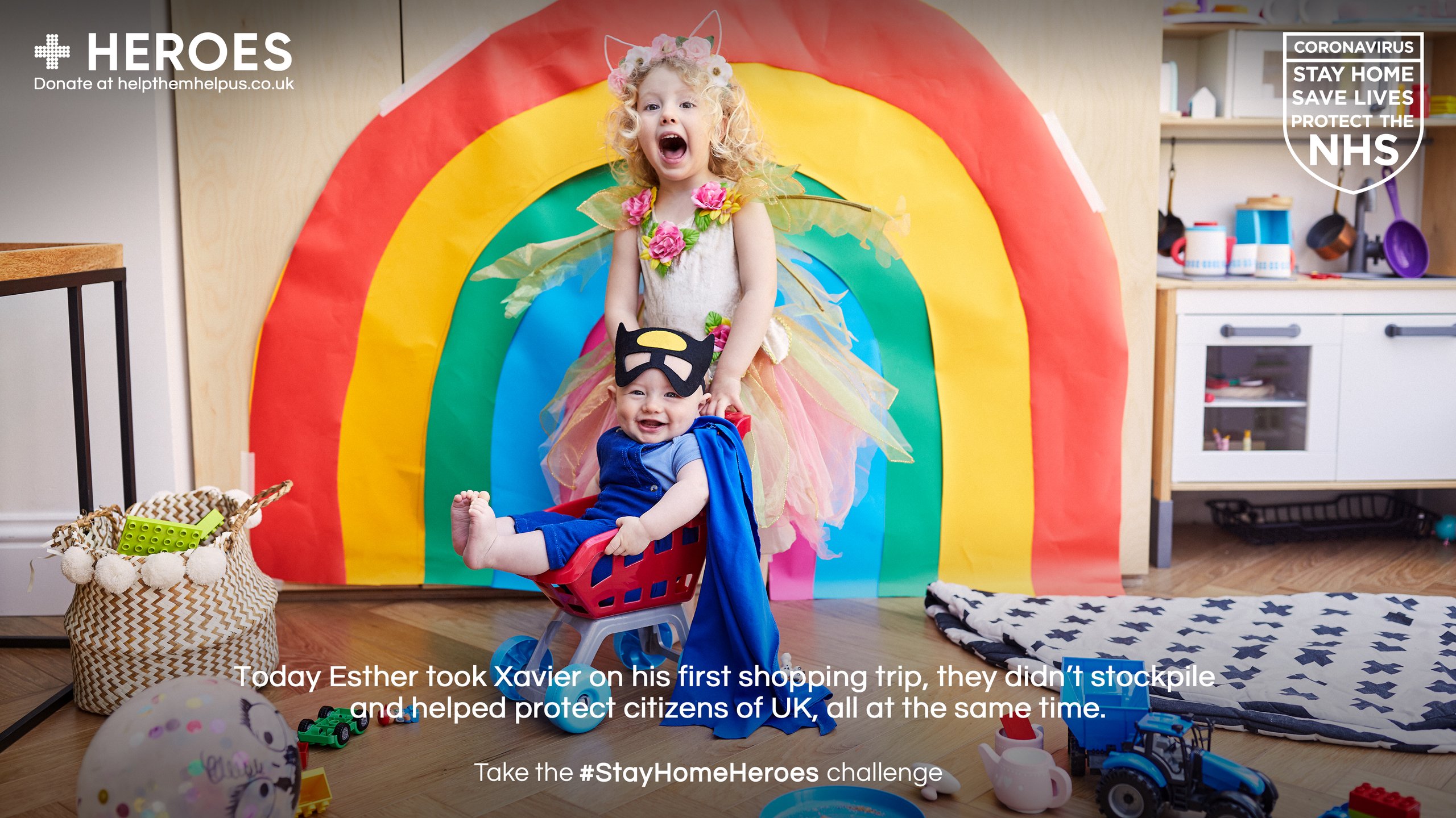 Two children in superhero costumes playing with rainbow painting for Stay Home Heroes campaign