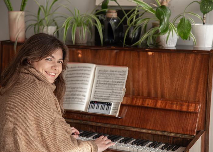 a motivated girl learning piano