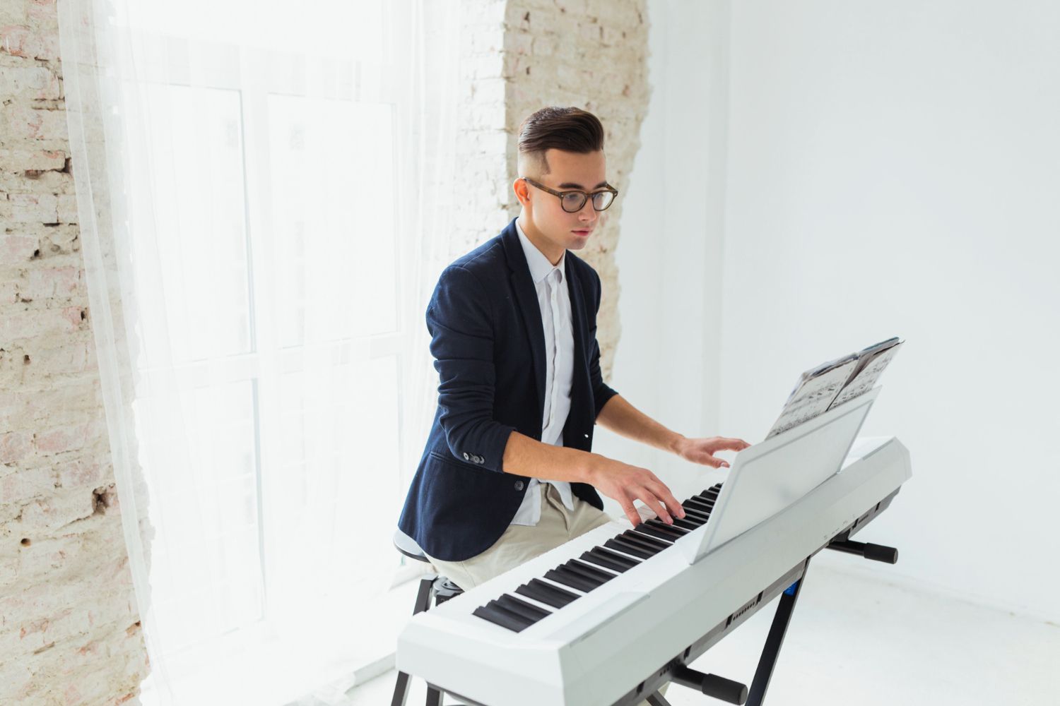 Person learning piano independently at home with sheet music
