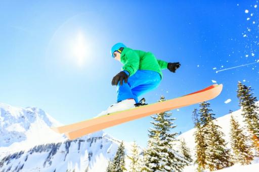 person on top of skiing board - How Many Calories Does Skiing Burn