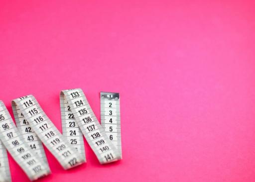 a measuring tape - Do Resting Calories Count Towards Deficit