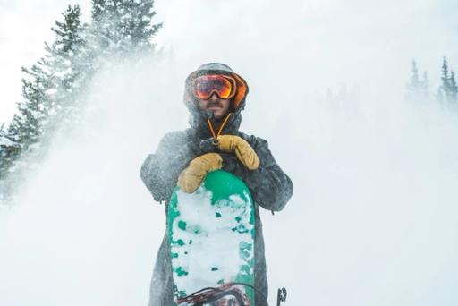 person on top of snowing board - How Many Calories Does Skiing Burn
