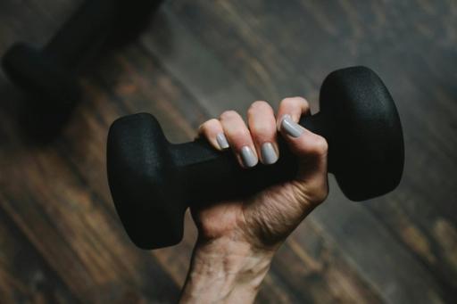 Person Holding Dumbell - MacroFactor vs Myfitnesspal