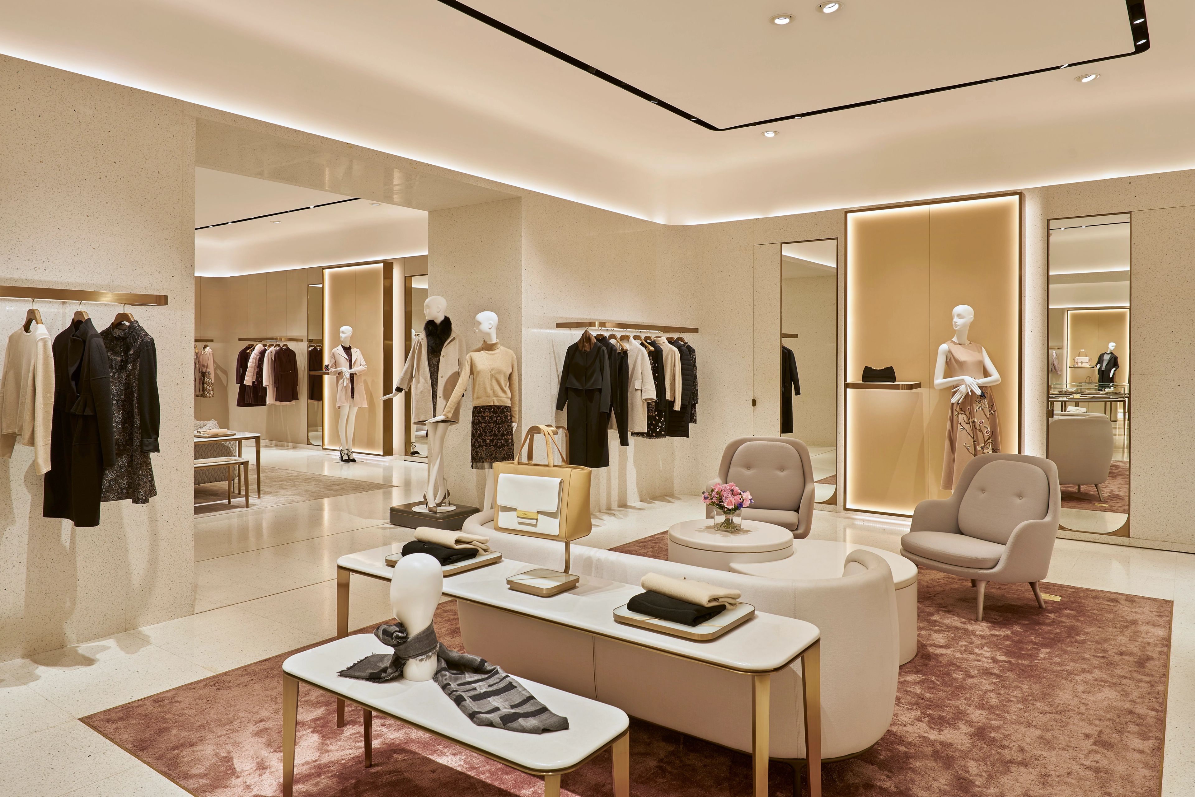 Luxury fashion interior at the V Grass Nanjing Flagship Store, featuring contemporary retail design, premium merchandise displays and elegant fitting areas.