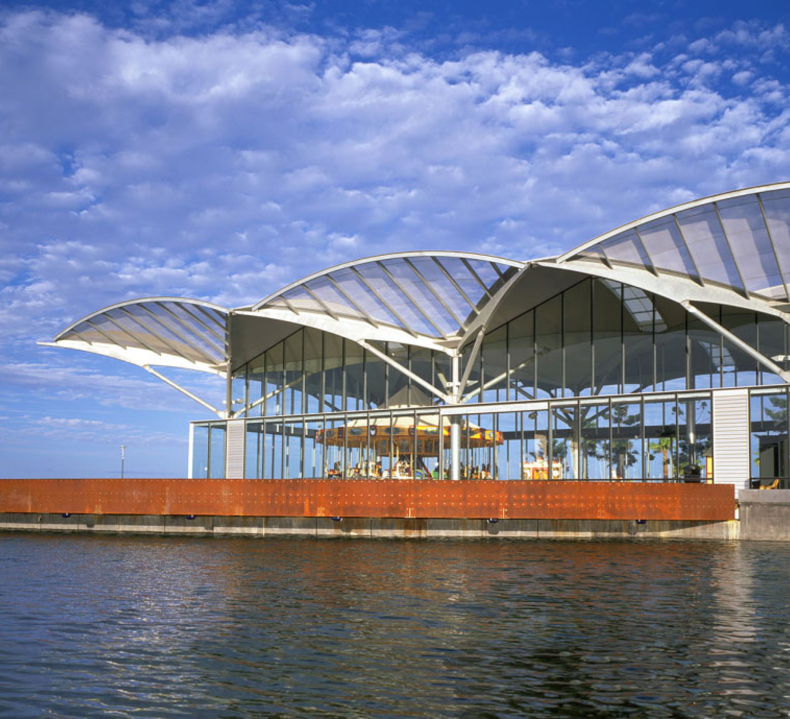 The Carousel Pavilion expresses both elegance and functionality, allowing the carousel to be fully visible from multiple viewpoints while maintaining a light and open presence within the precinct.