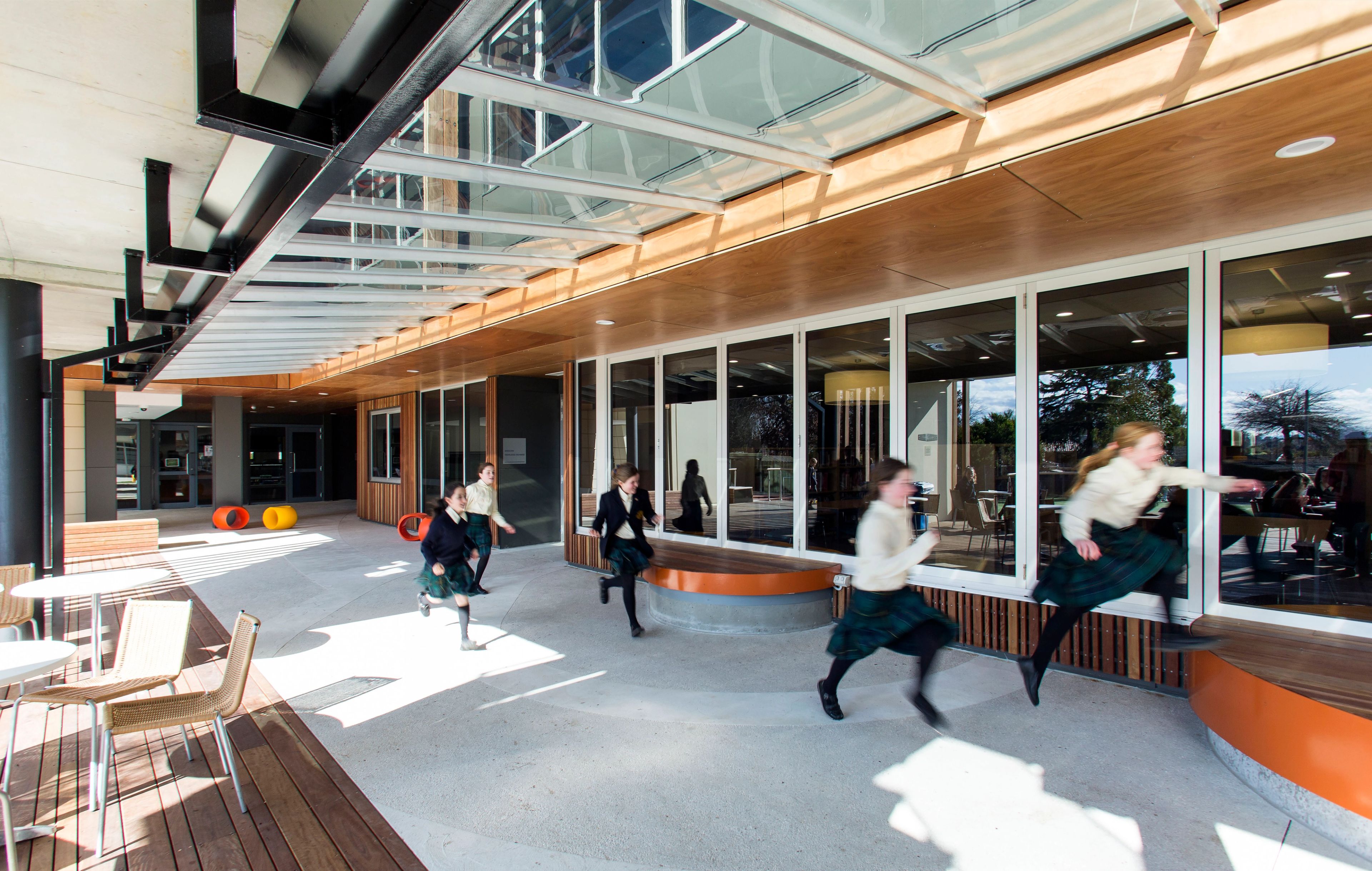 Students move through the covered outdoor learning space at the Strathcona Girls Grammar School Learning Centre, connecting classrooms with flexible communal areas.
