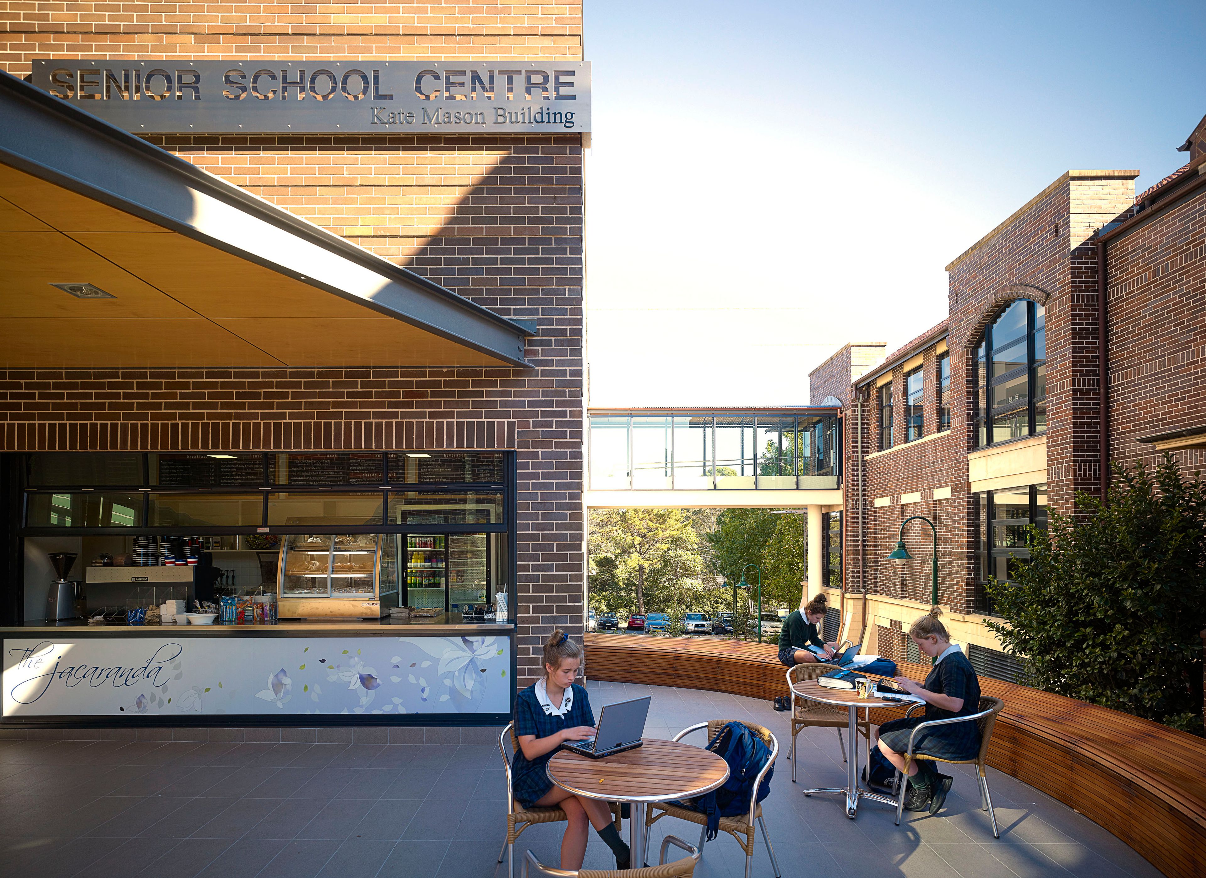 Students study outside The Jacaranda Café at the Kate Mason Building, Pymble Ladies' College, showcasing contemporary learning spaces within a heritage campus.