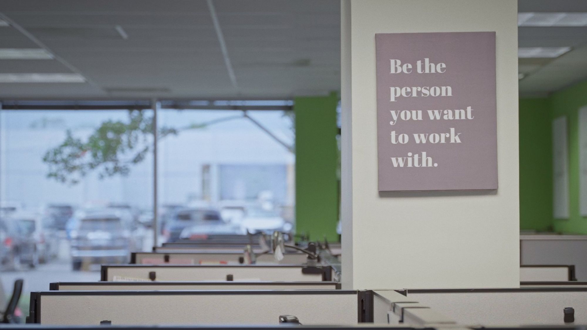 Office sign reading "Be the person you want to work with" during a Boda Studios shoot