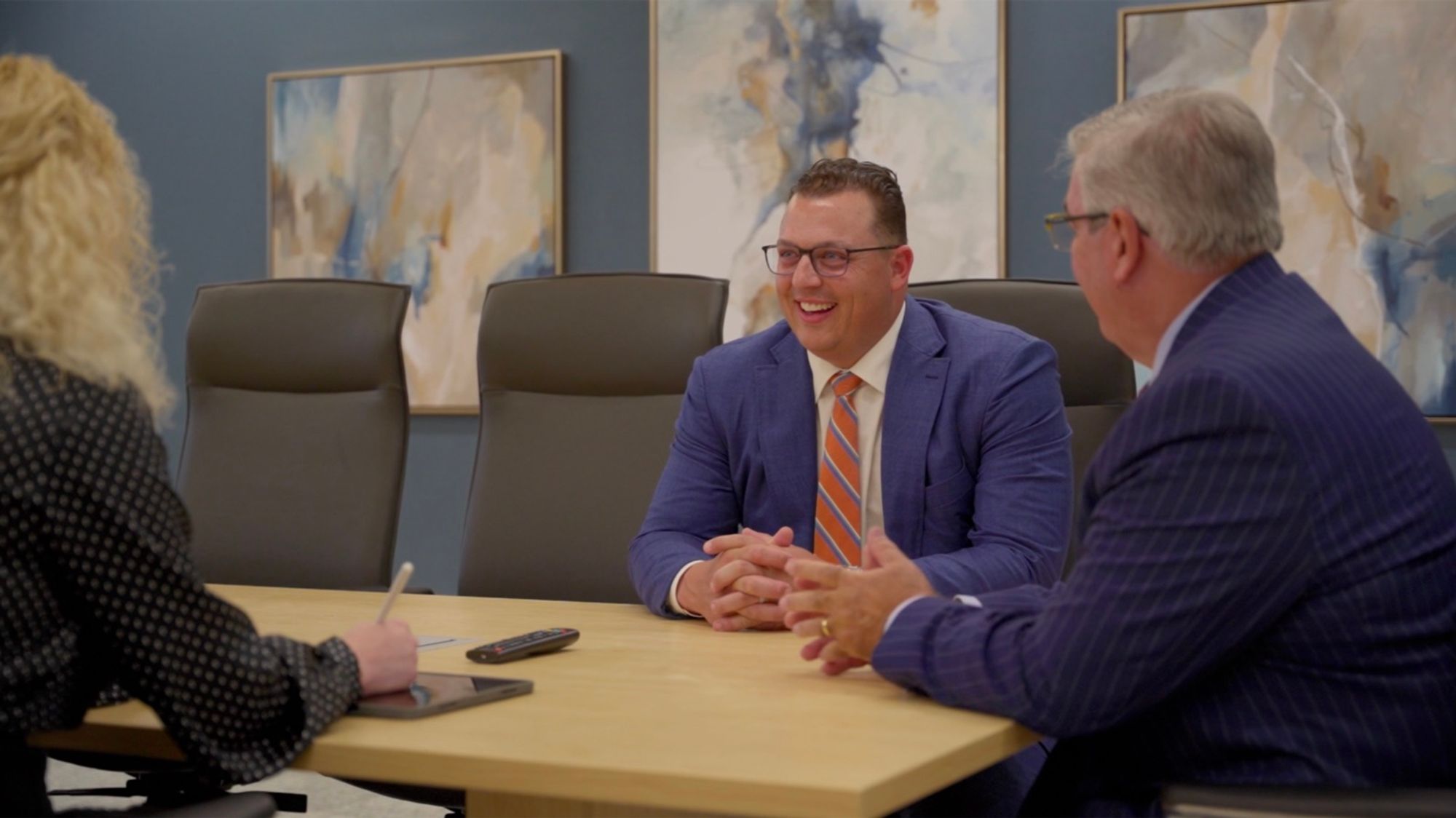 Colleagues in conversation around a conference table