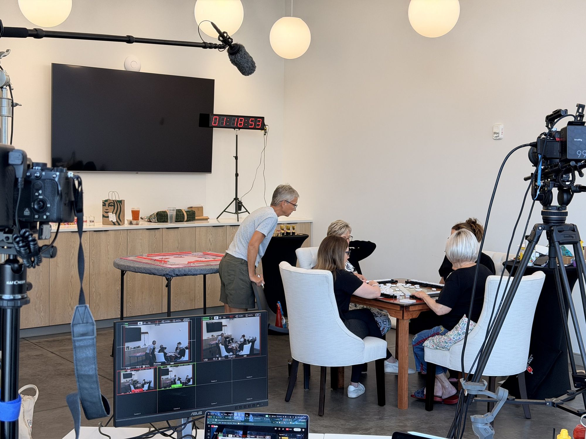 The Boda Studios crew filming a multi-camera shoot, with monitors and a timestamp clock visible on set