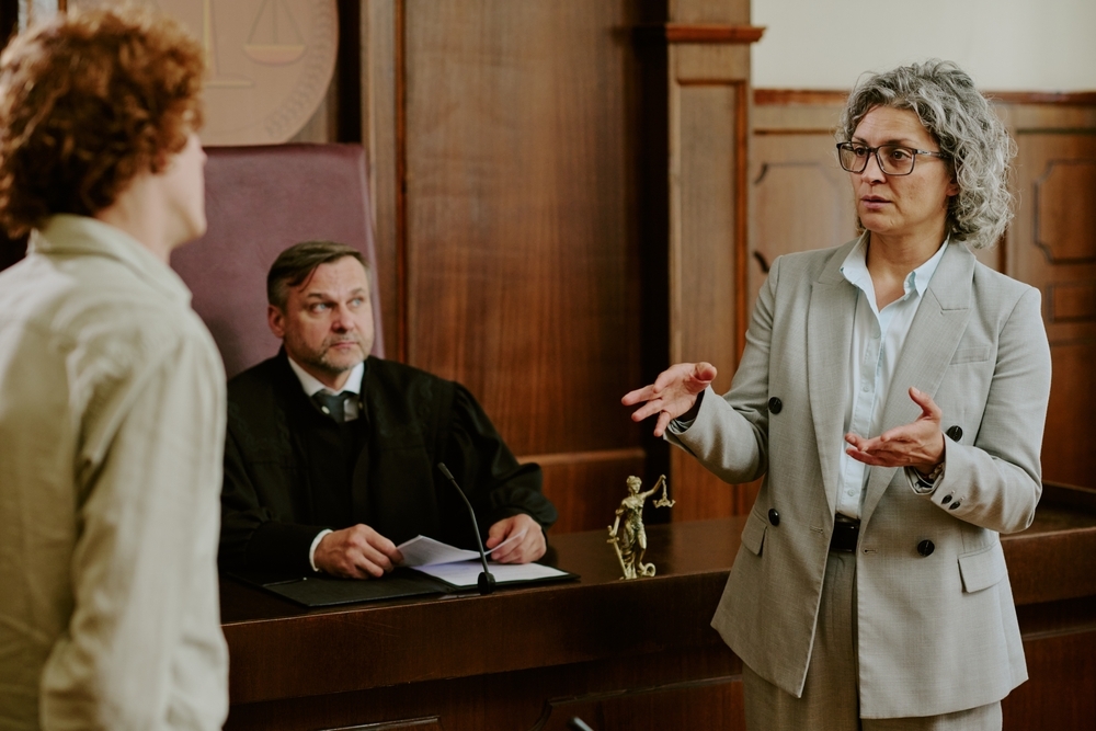 Image Defense attorney speaking in a courtroom during a fake ID case hearing.