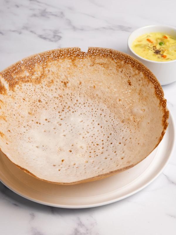Soft, lacy Kerala appams served with a fragrant coconut-based vegetable stew simmered with aromatic spices.