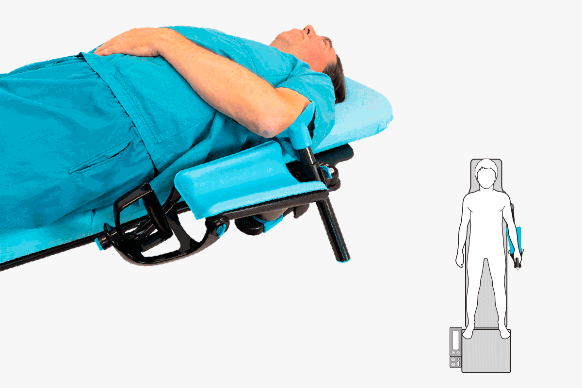 Patient in blue scrubs on a medical table with a blue arm support, illustrated by a top-down diagram.