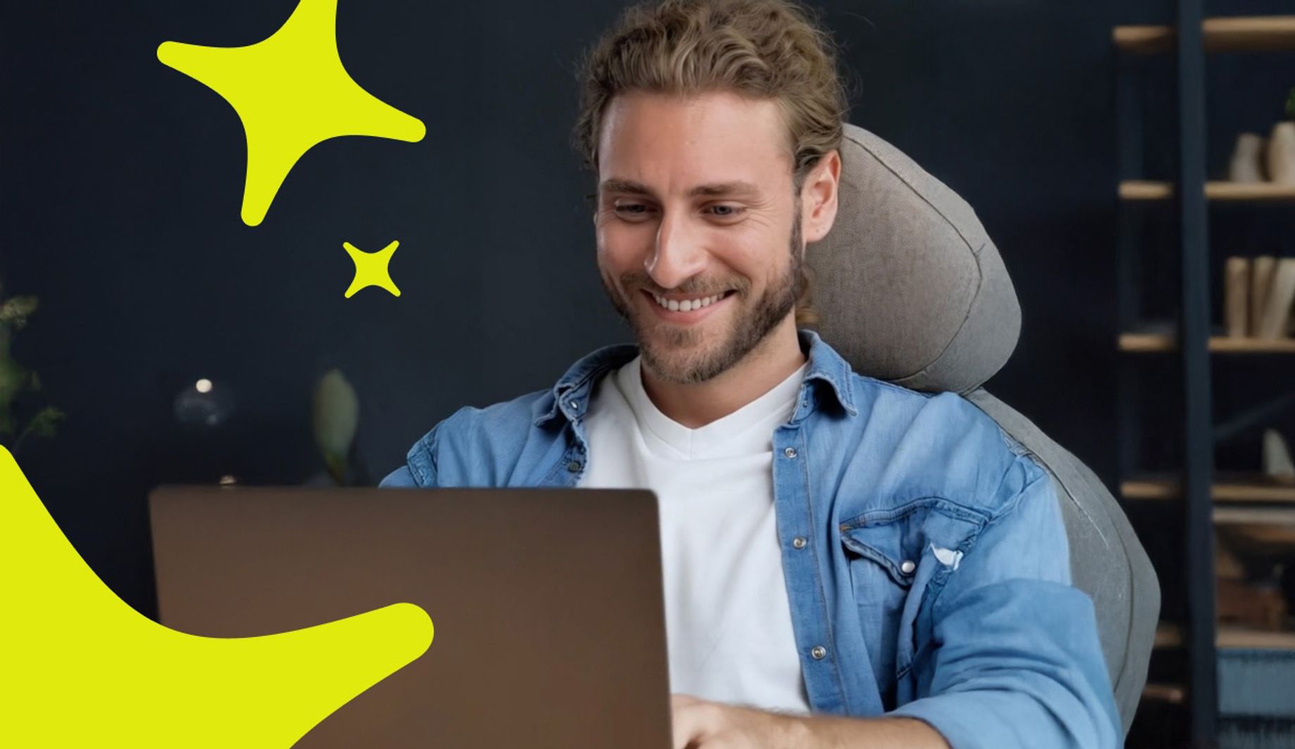 Man smiling at laptop with stars