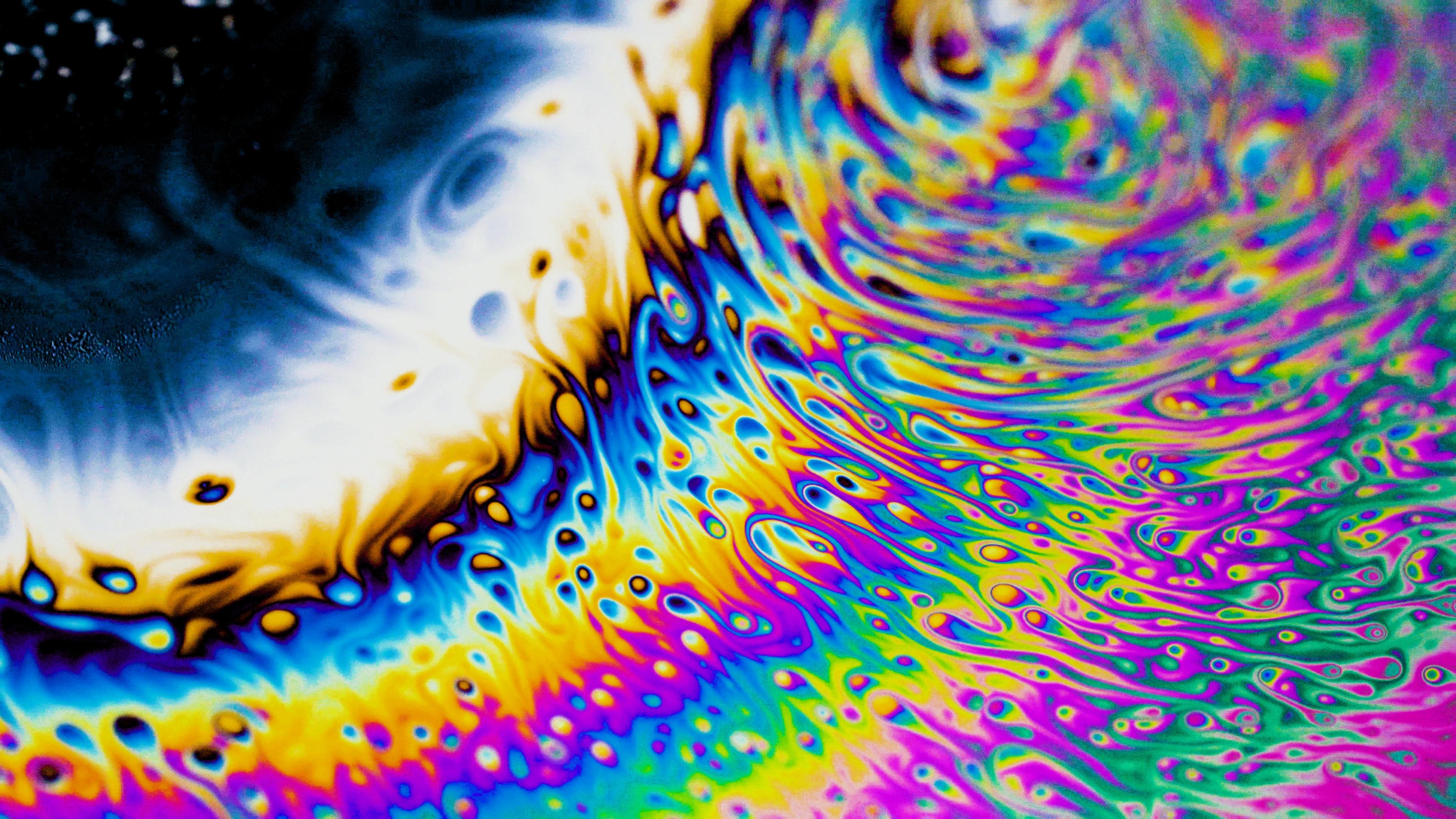 Macro shot of multicoloured bubble on water