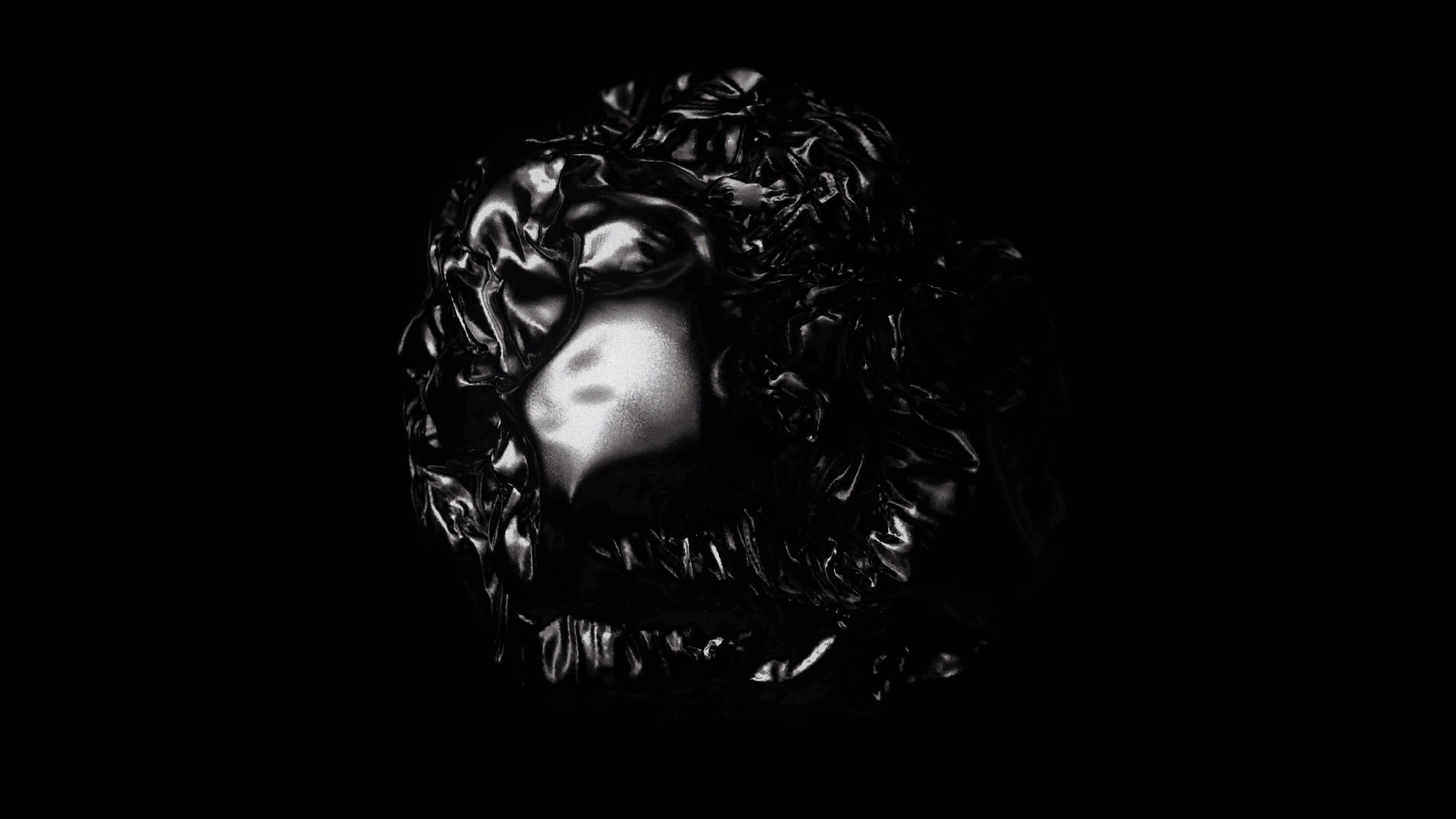 A black and white sphere covered in a dark material