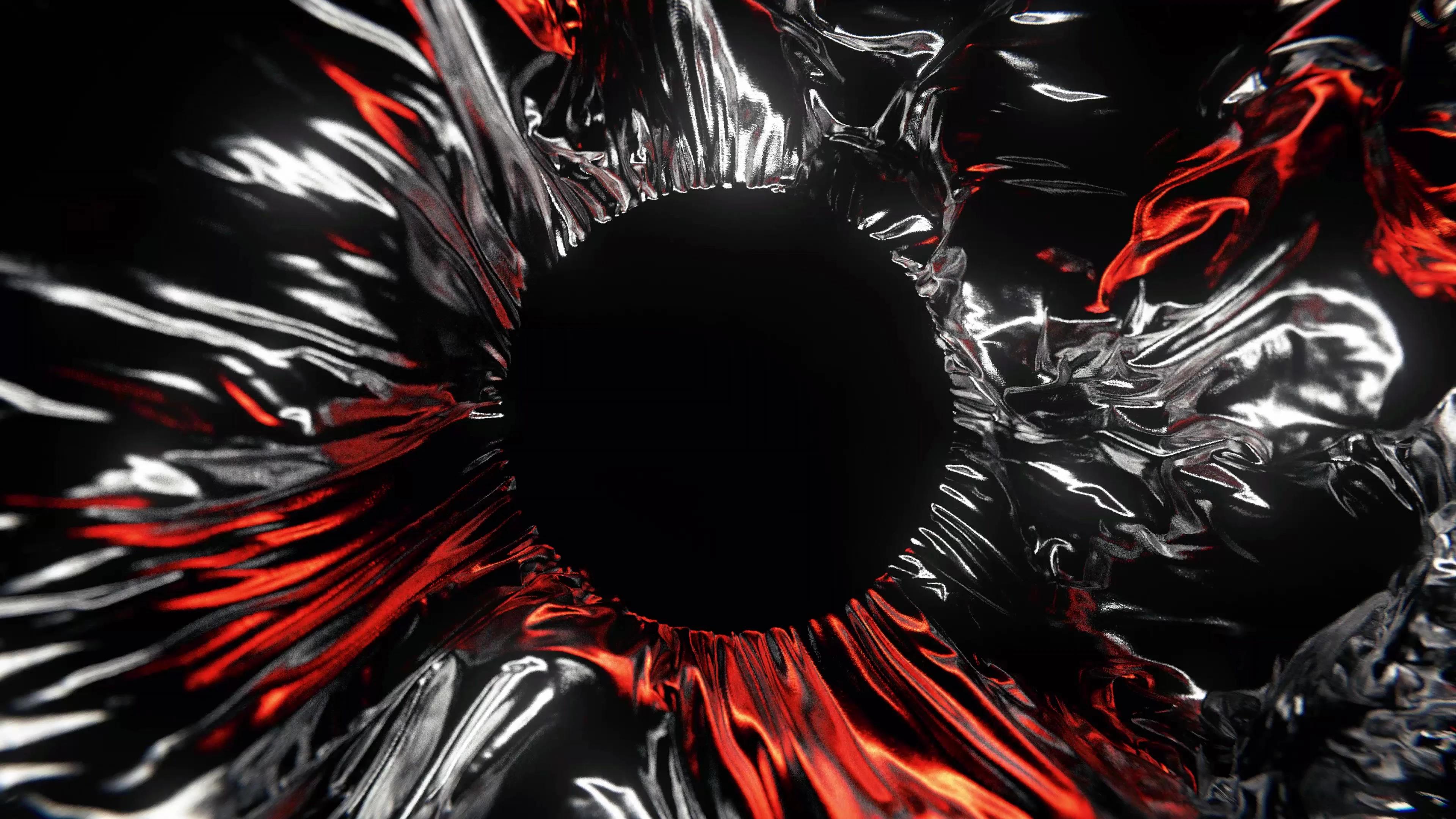 Red and silver fabric with a black hole in the centre