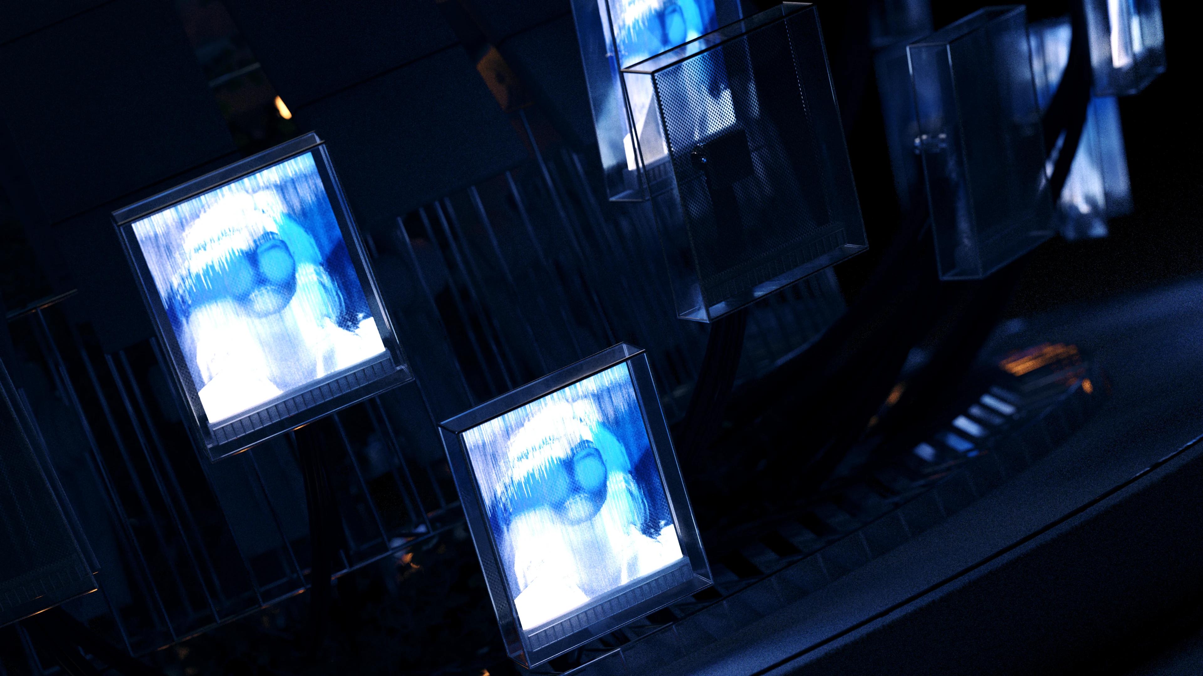 4 tv screens with a blue human face inside