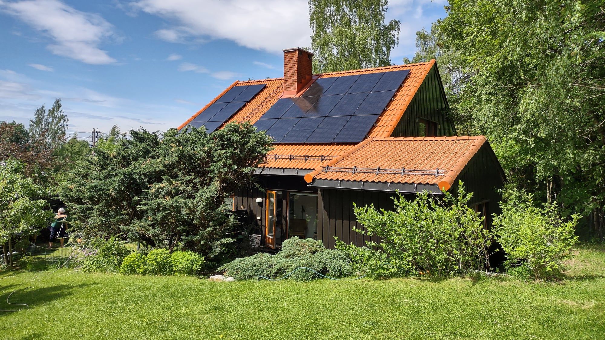 Hus med rødt tak og solcelleanlegg