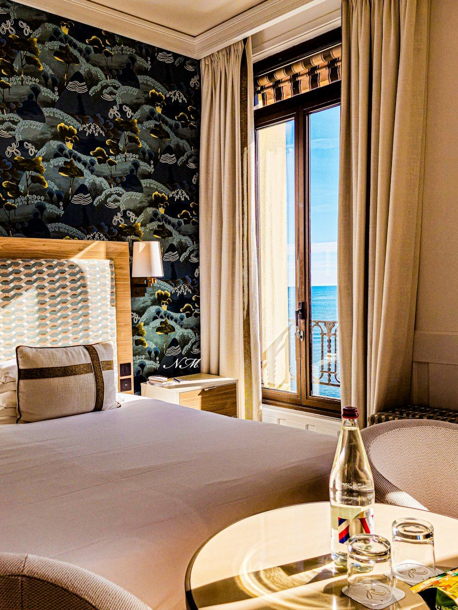 A bright hotel room with a large bed