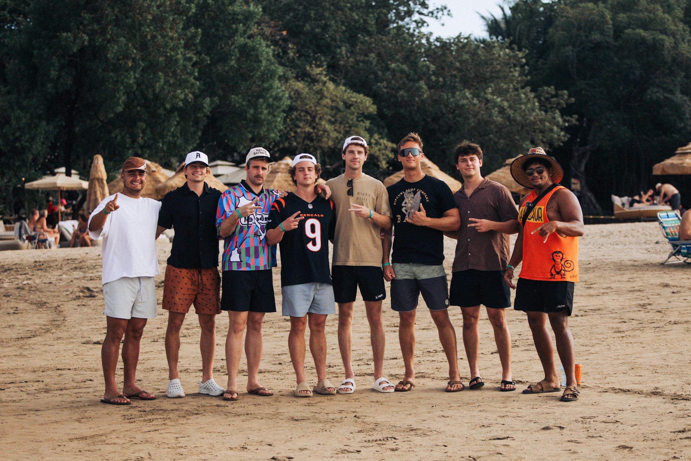 A group of friends posing on a sandy beach