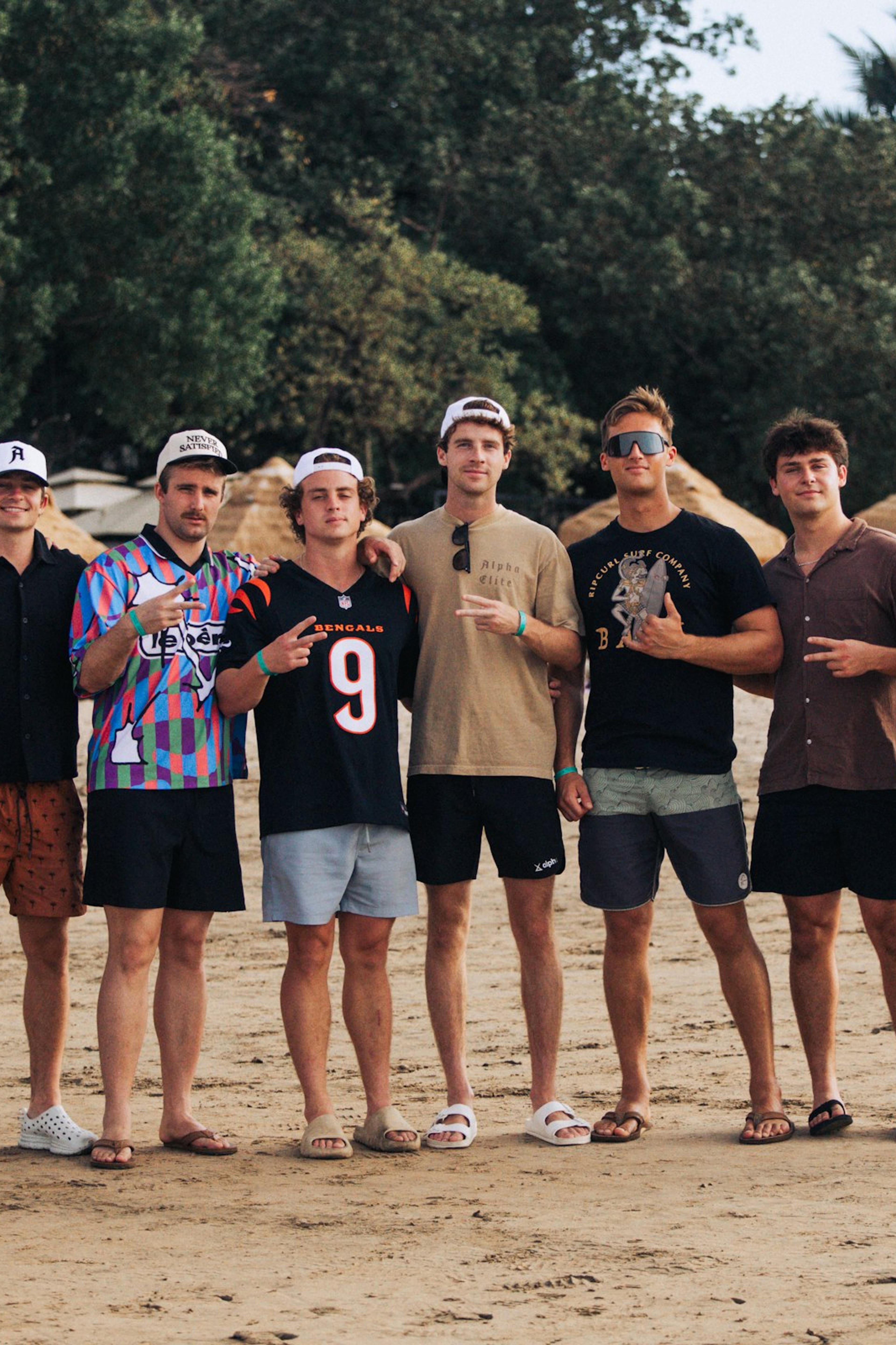 A group of friends posing on a sandy beach