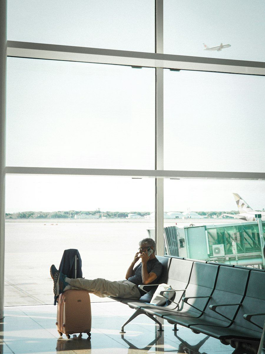 A business traveller working at the airport, by the runway